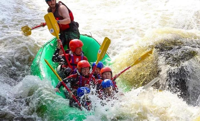 Bearded men adventures, group in raft going down town falls, Llangollen